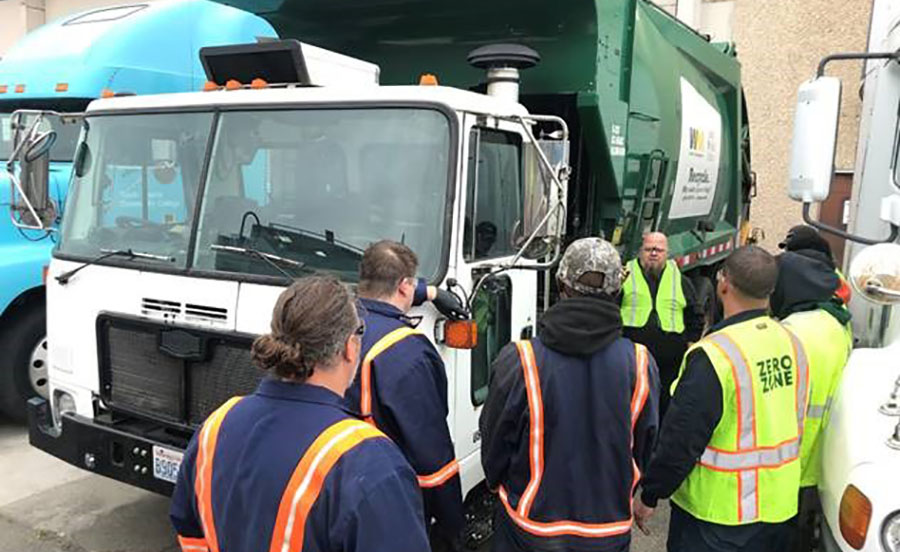 SSC Diesel & Heavy Equipment Instructor Jeremie Pitts discussing the newly donated truck with students at South Seattle College (photo courtesy of Waste Management)